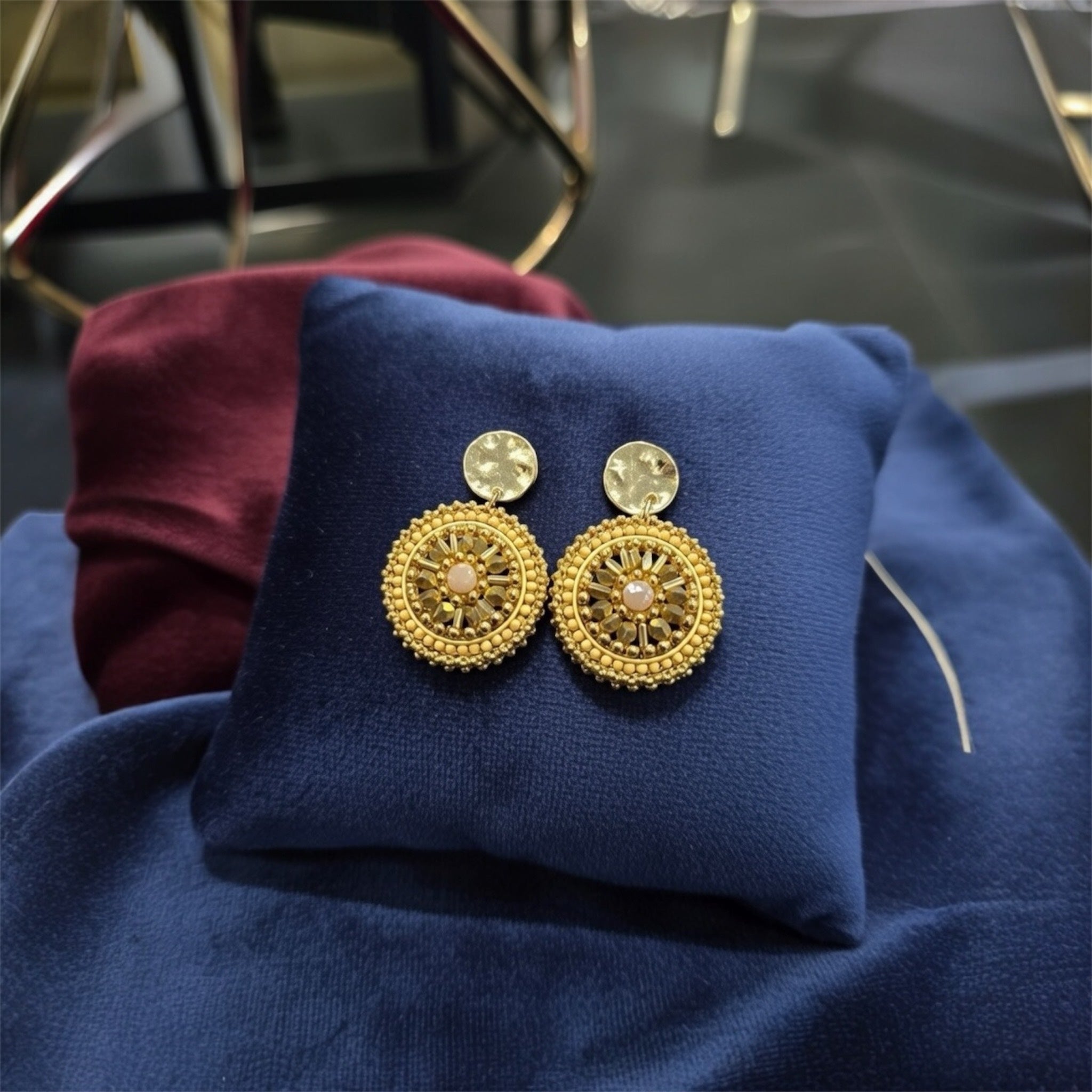 Forgyldte øreringe fra Maq Jewelry med gyldne perler og rosa midte